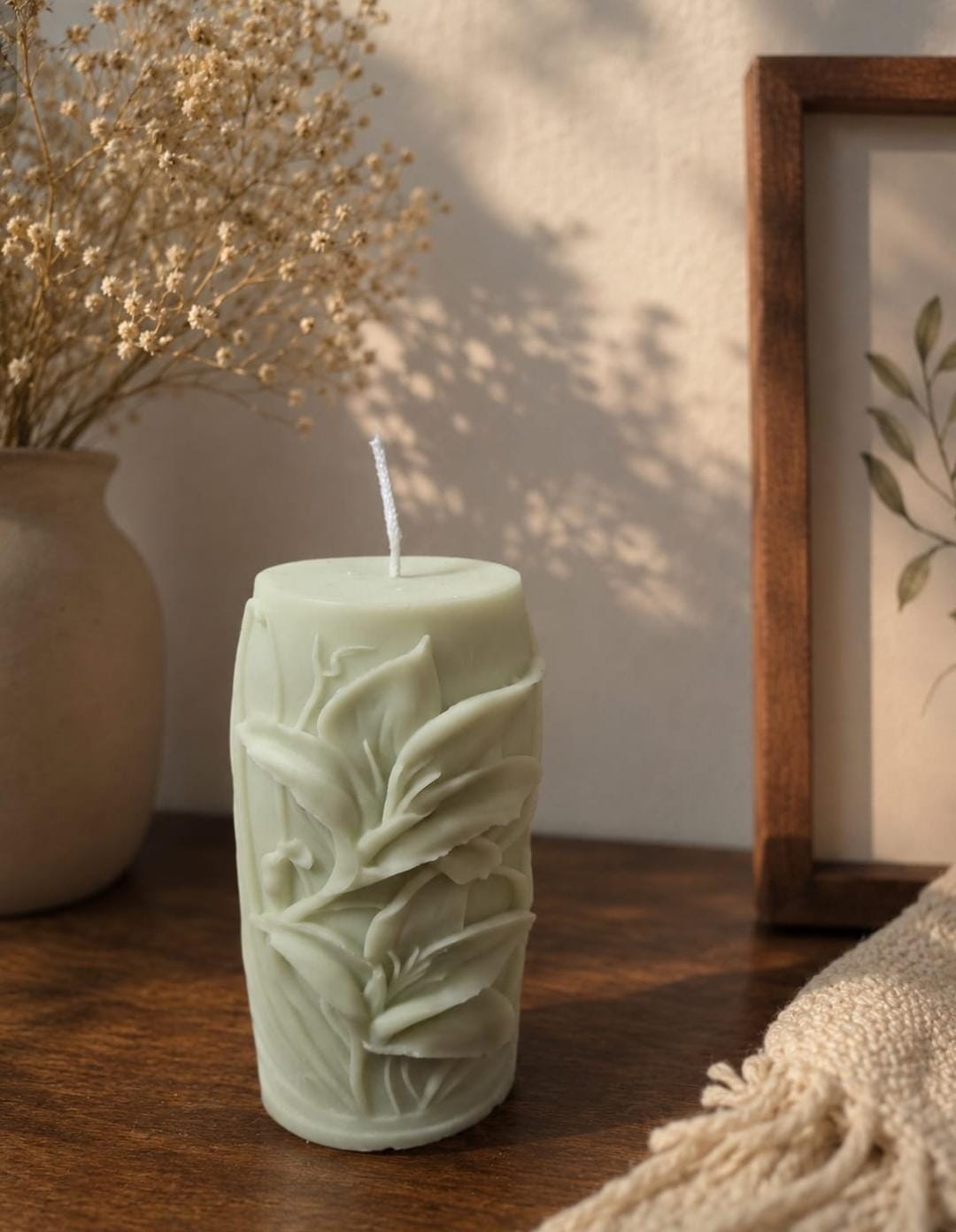 Handmade pillar candle with botanical leaf design